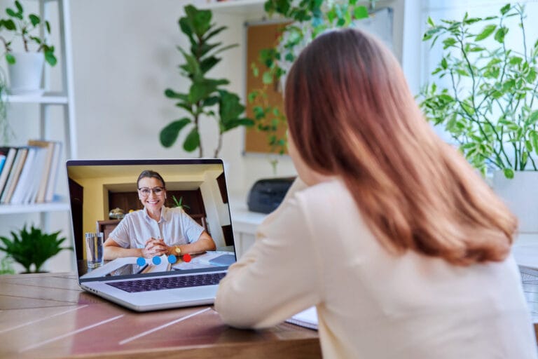 Virtual anxiety therapy session with a smiling McDowall therapist