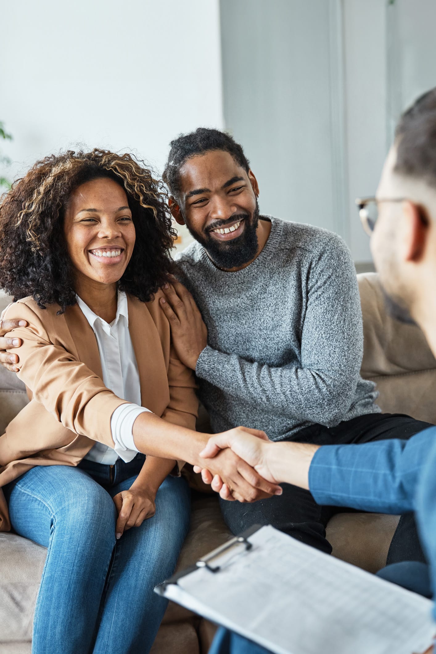 Client smiling with her McDowall therapist while reviewing an anxiety treatment plan