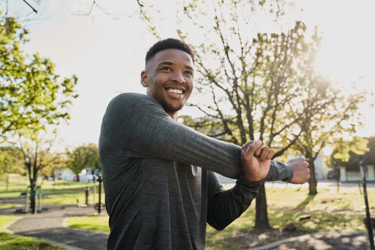Man practising calming breathing and grounding techniques outdoors