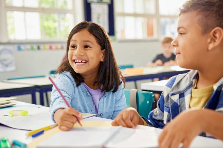 Child with ADHD staying engaged while writing at her school desk