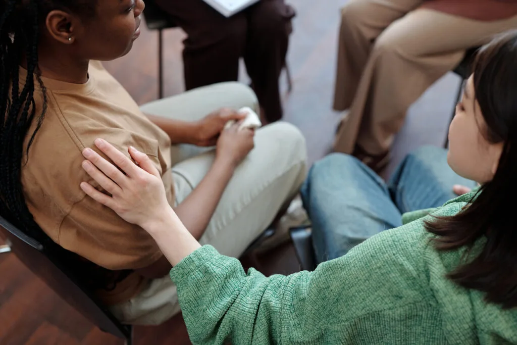 Girl comforting friend during session