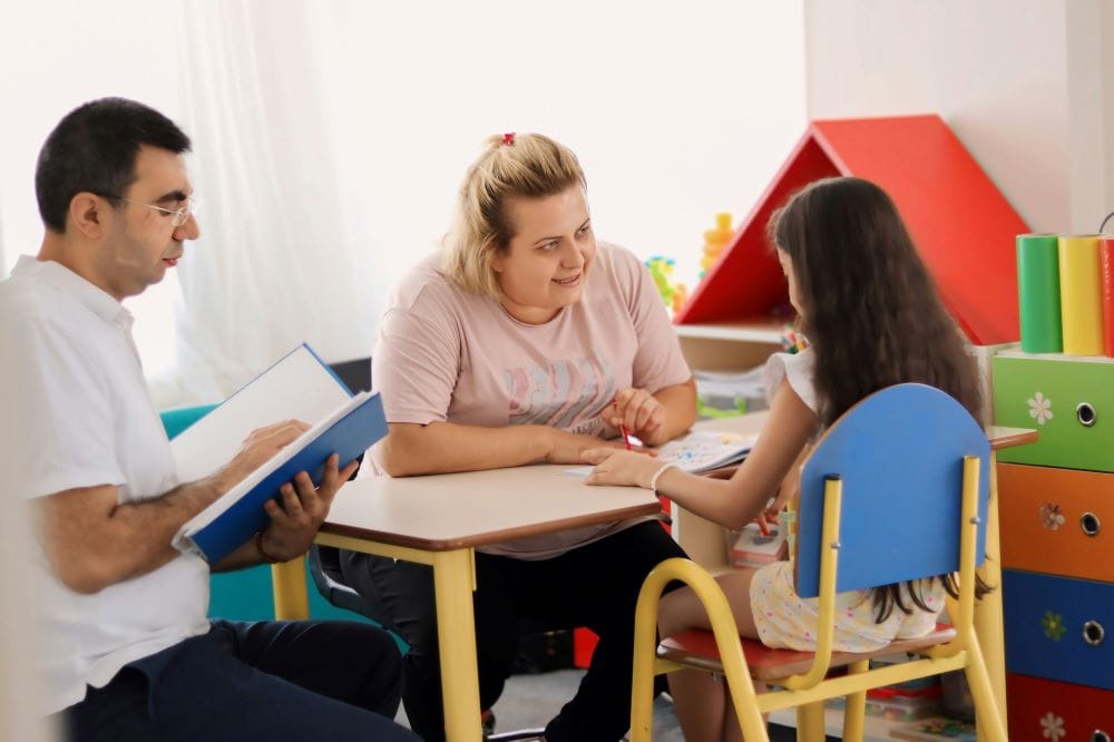 mother and psychologist taking care of psychoeducational assessments of a child