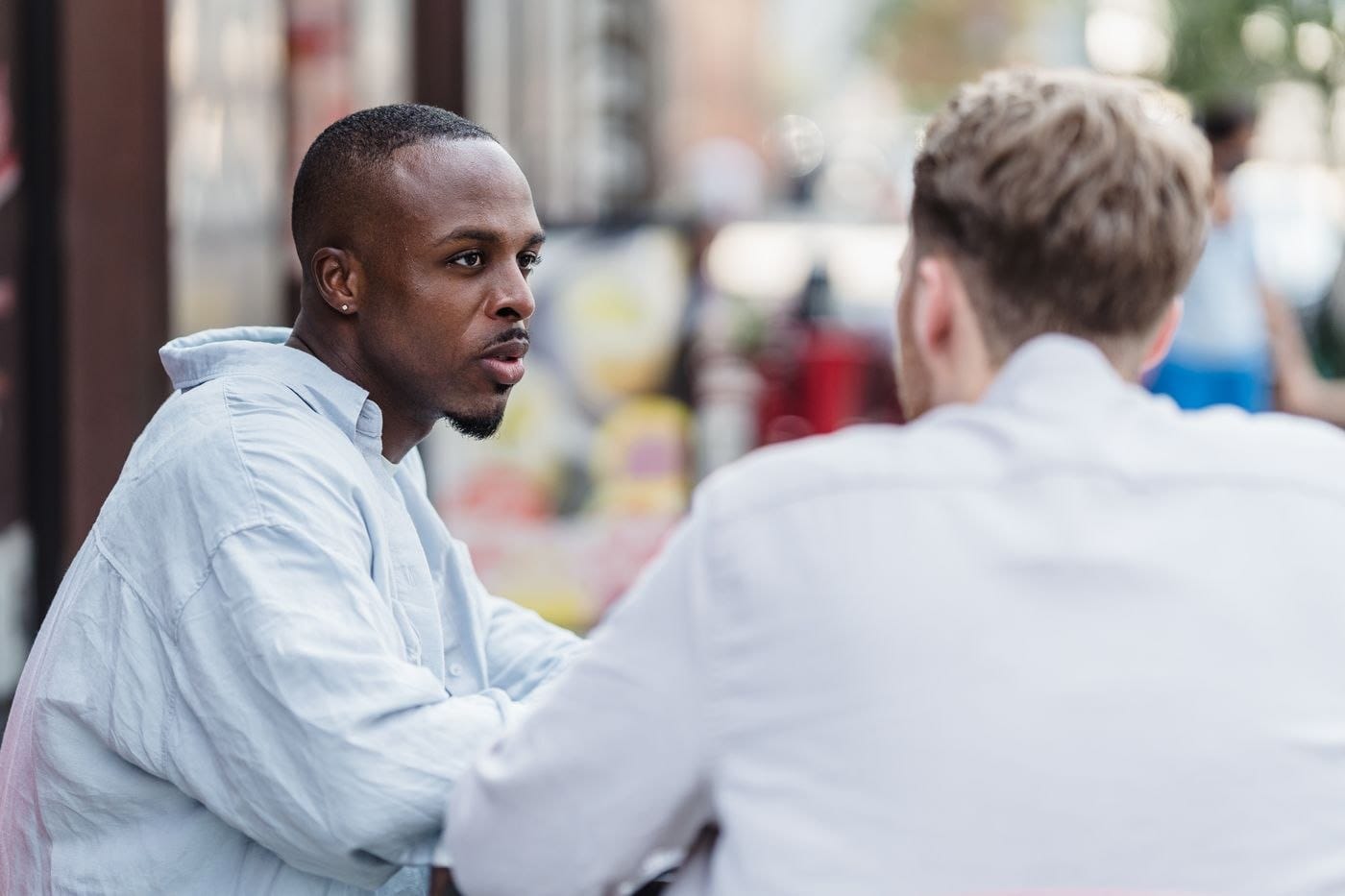Man being listened to with support during a trauma counselling conversation