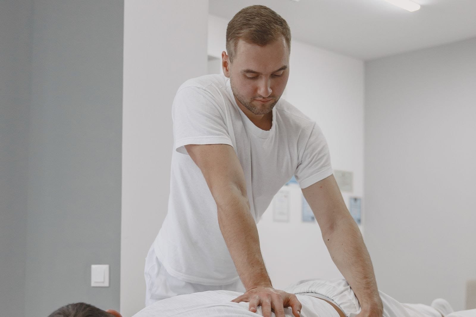 Naturopathic doctor treating a client on the clinic table