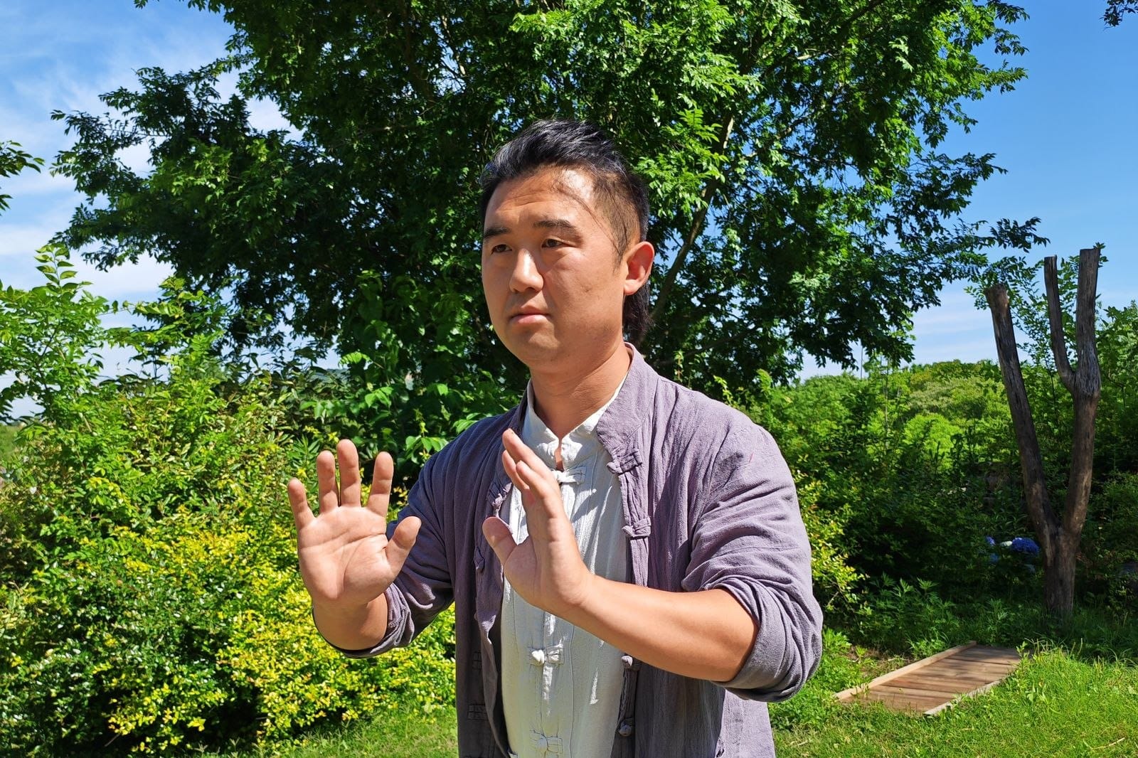 Man practising tai chi and qigong outdoors — the roots of energy therapy